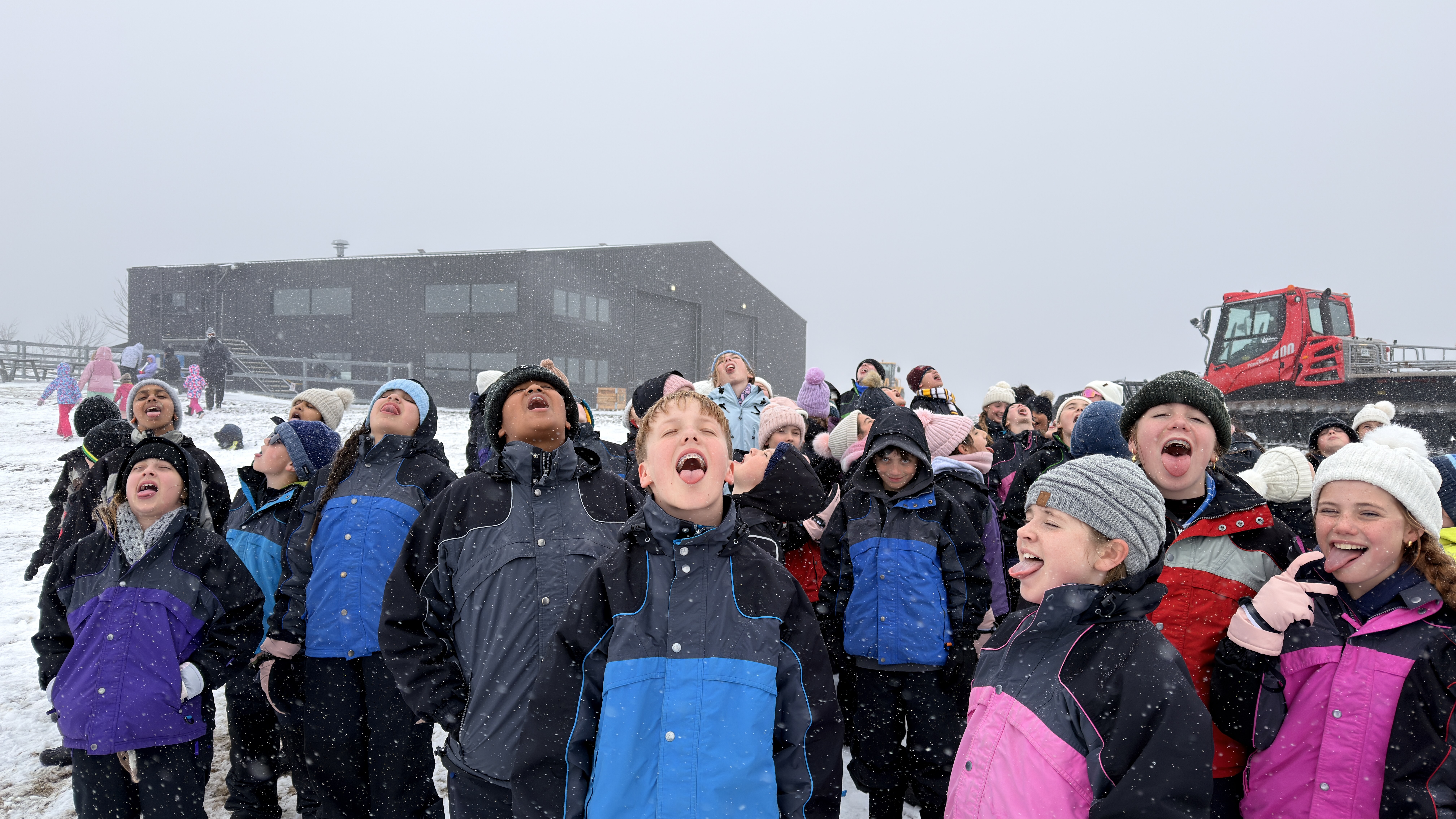 Students catching snow on their tongue